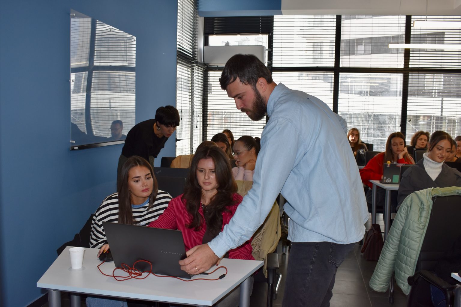 Instructor mentoring students during a class at Creative Hub
